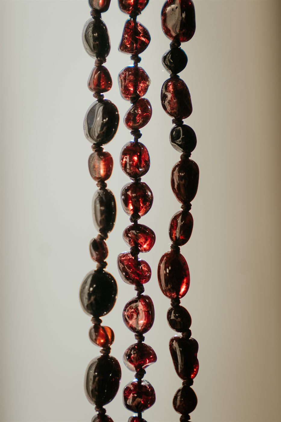 Garnet necklaces glowing in the light